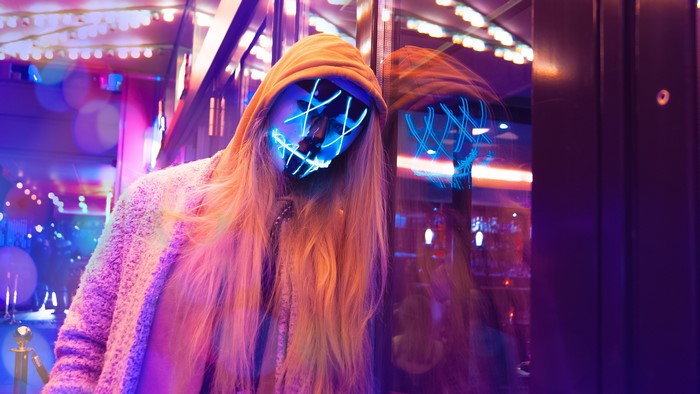 Woman in Anonymous mask with neon lights