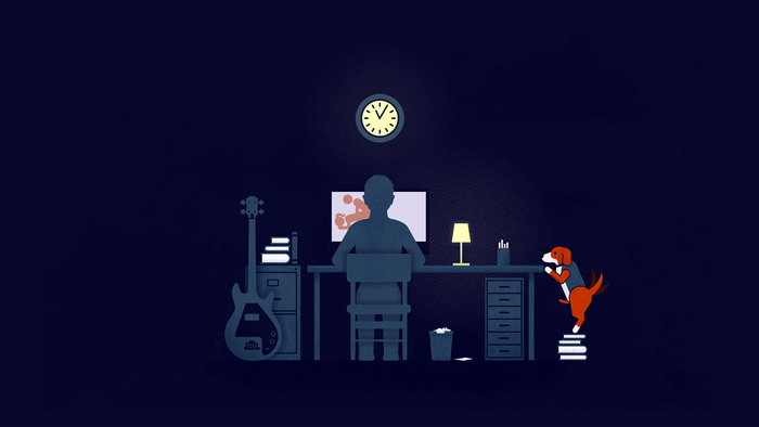 Man at computer with dog and guitar