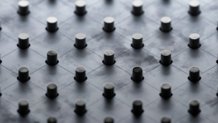 Gray metal texture with a grid pattern of cylindrical studs