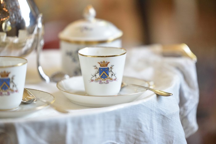 Teacup with crest and spoon on a table