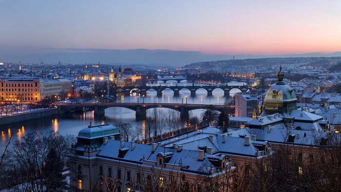 Prague cityscape with bridges over the Vltava River at dusk