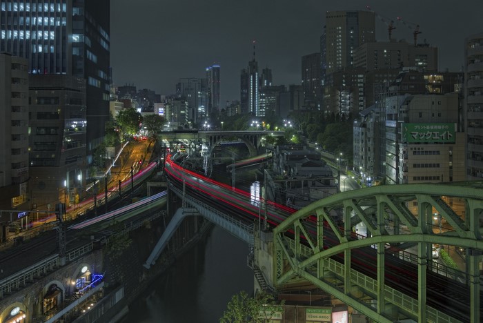 Light trails from trains in Tokyo cityscape at night