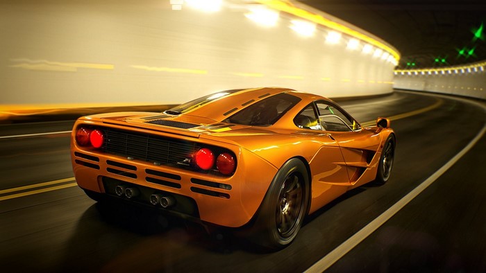 Orange McLaren F1 driving through a tunnel