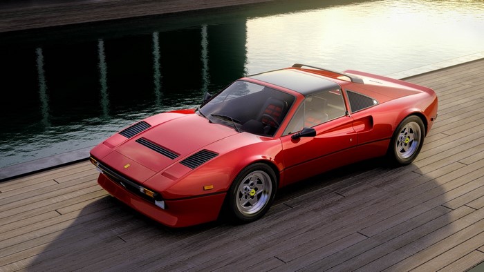 Red Ferrari 288 GTO parked on wooden deck by water