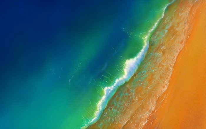 4K Aerial View of Ocean Waves and Sandy Beach
