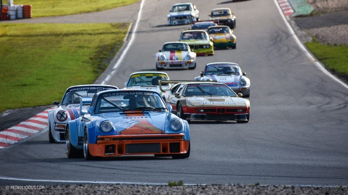 Classic Porsche 911 and BMW M1 race cars on track