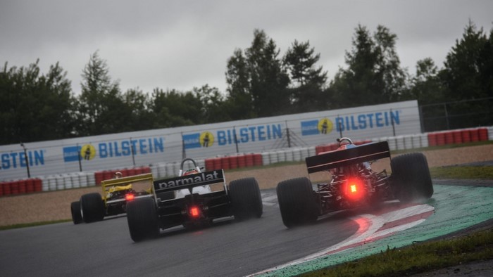Formula 1 cars racing on a wet track with Bilstein banners