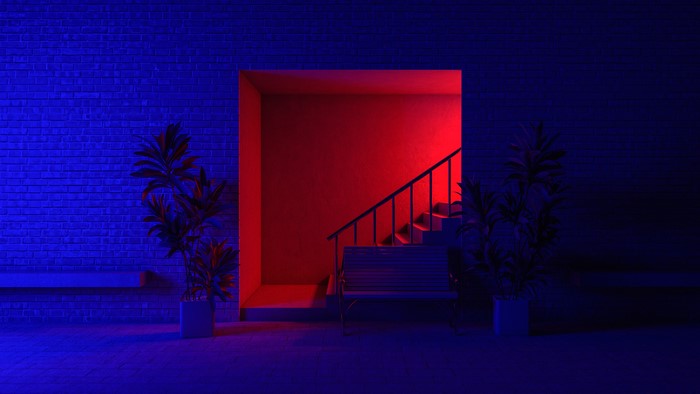 Stairs and bench illuminated by red and blue neon lights