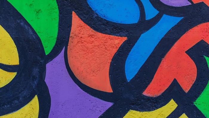 Colorful graffiti art on a textured wall