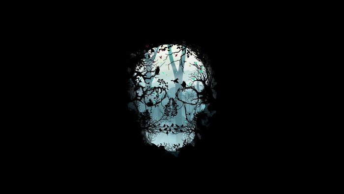 Skull silhouette filled with a forest scene and birds