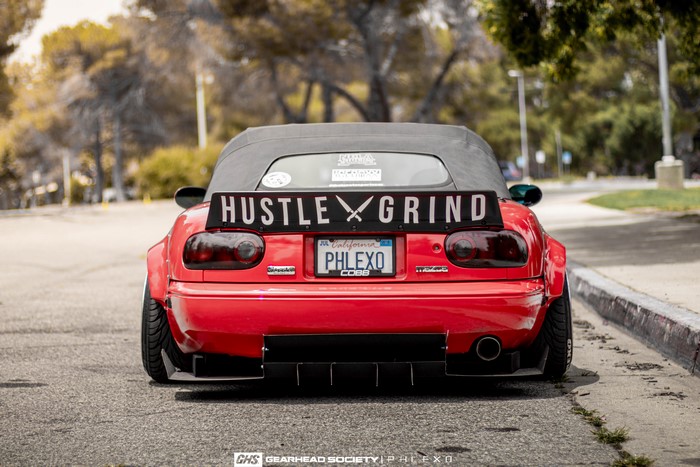 Red Mazda MX-5 with widebody kit and custom spoiler