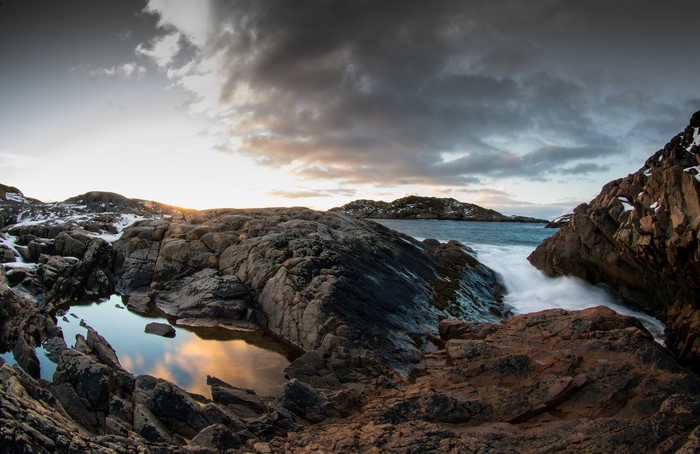 Rocky coastline with waves crashing in Norway