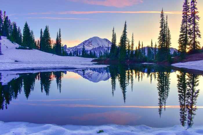 Mount Rainier reflected in a lake at sunset with snow