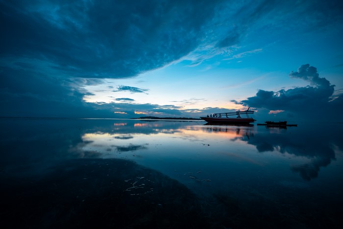 4K sunset reflection on water with boats in Bali