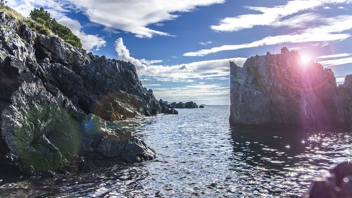 Rocky coastline with sea and sun