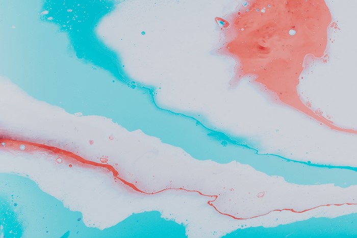 Abstract paint splash with cyan and orange colors