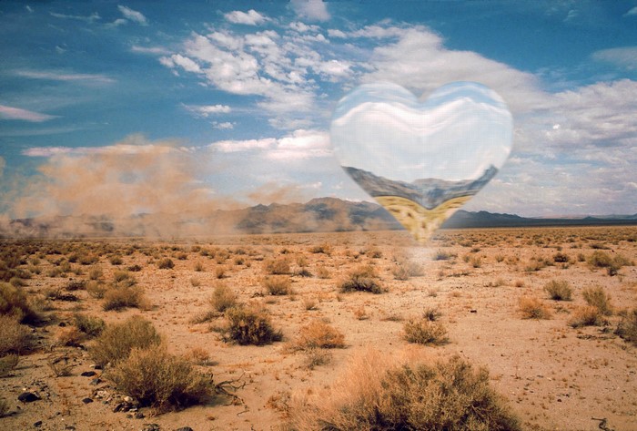 Heart-shaped UFO over a desert landscape