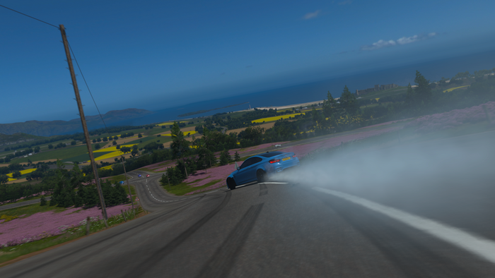 Blue car drifting on a road in Forza Horizon 4