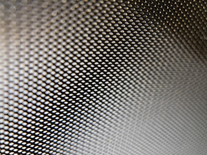 Close-up of a metallic mesh with bokeh effect