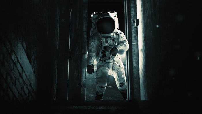 Astronaut in a dark doorway