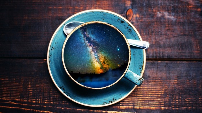 Coffee cup reflecting the Milky Way galaxy
