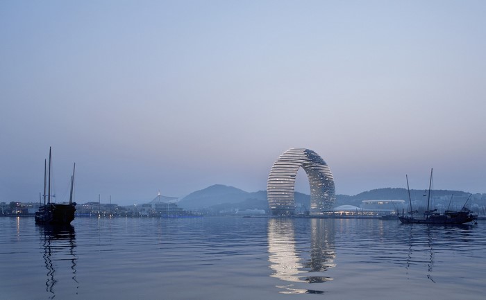 Modern circular building on a waterfront with boats