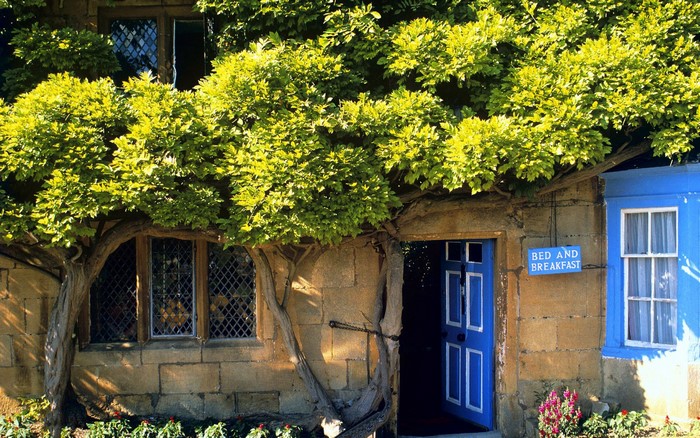 Bed and Breakfast building with blue door and windows