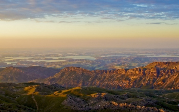 Mountain range at sunrise with distant lakes