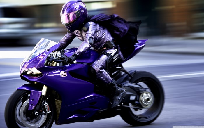Hit-Girl from Kick-Ass riding a purple motorcycle
