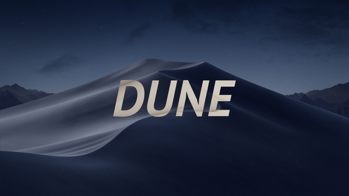 Dune typography over desert dunes at night