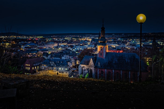 Cityscape at night with church and street lamp