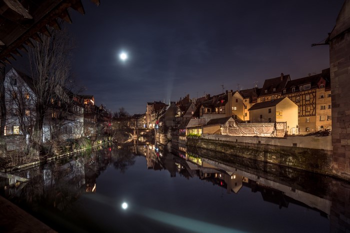 Night view of Nuremberg cityscape with river reflection