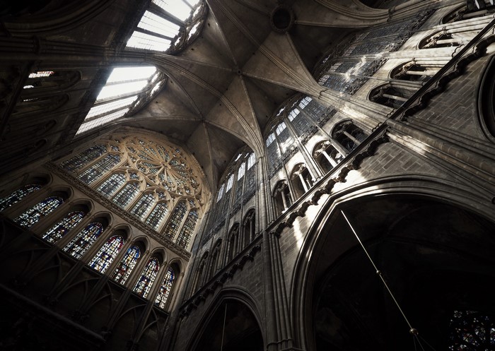 Cathedral interior with stained glass windows and vaulted ceiling