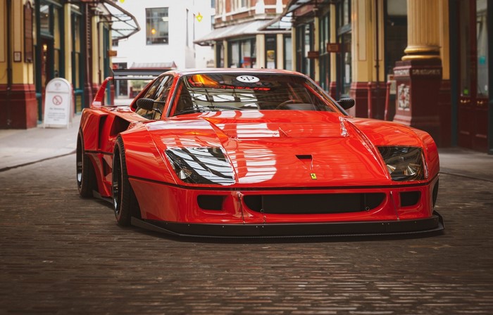 Red Ferrari F40 parked in a European alley