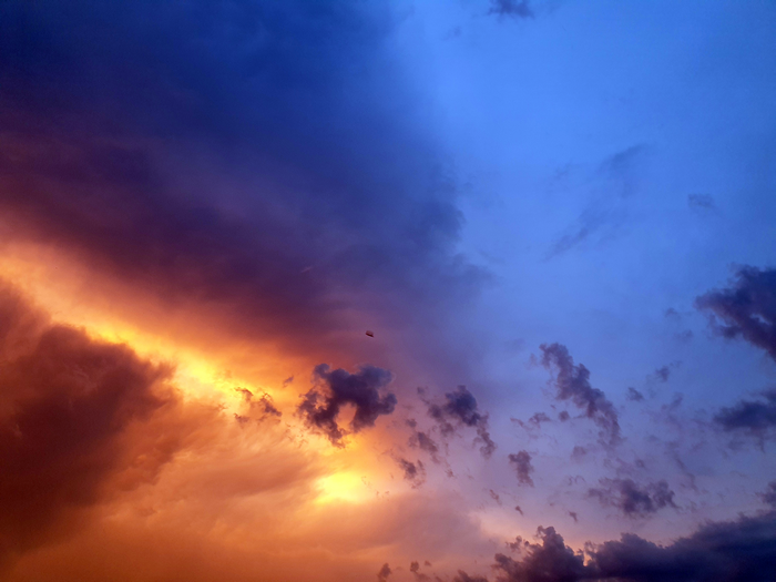 Stormy sky with orange and blue clouds