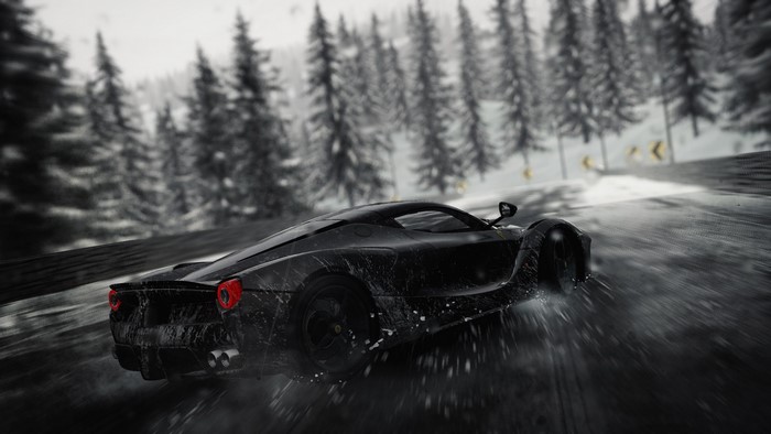Black sports car driving on a snowy road