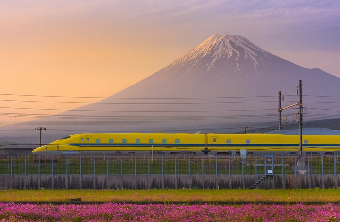 Yellow Shinkansen train with Mount Fuji in Japan