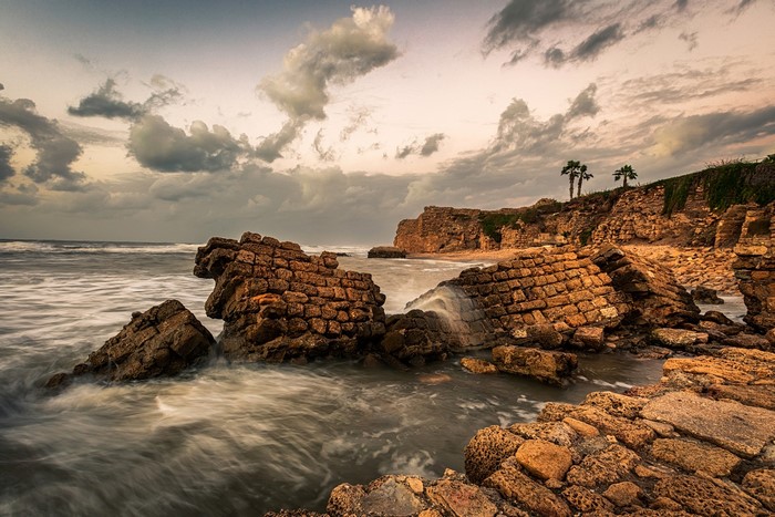 Ancient stone ruins on a rocky coast with the sea