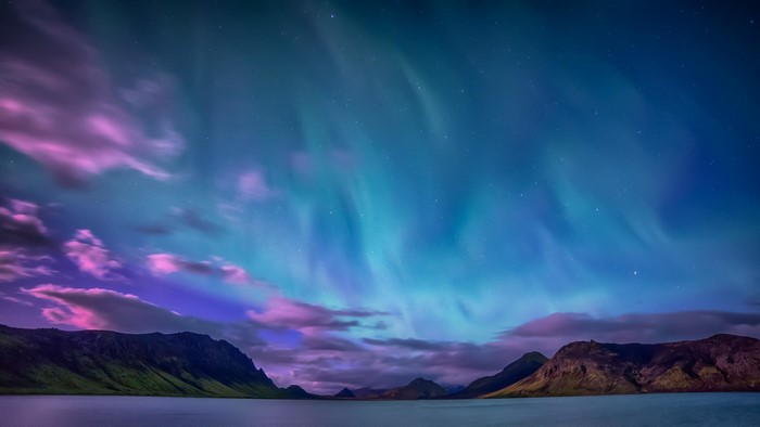 Aurora Borealis over mountains and water