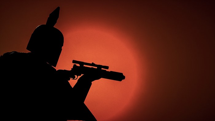 Boba Fett from Star Wars holding a rifle