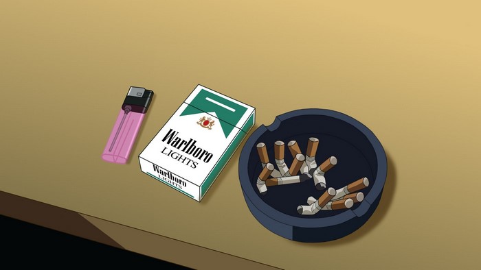 Pack of Marlboro Lights cigarettes, lighter, and ashtray with cigarette butts