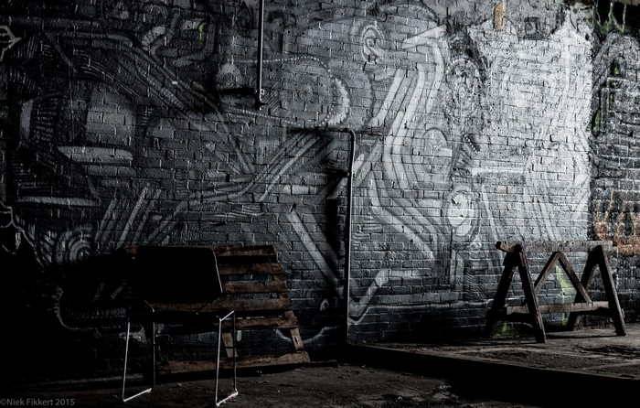 Graffiti wall in a dark urban factory