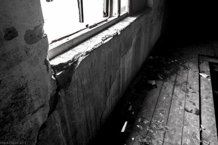 Abandoned factory interior with broken window