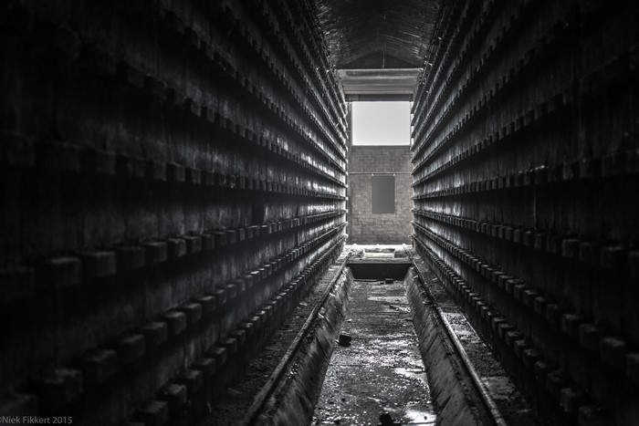 Abandoned factory interior with rows of shelves