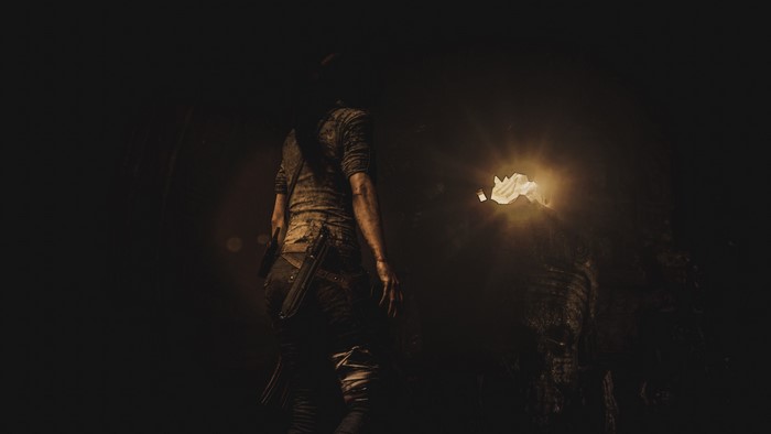 Lara Croft from Shadow of the Tomb Raider in a cave