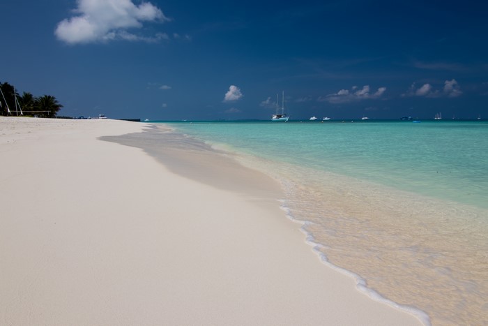 Tropical beach with boats in the Maldives