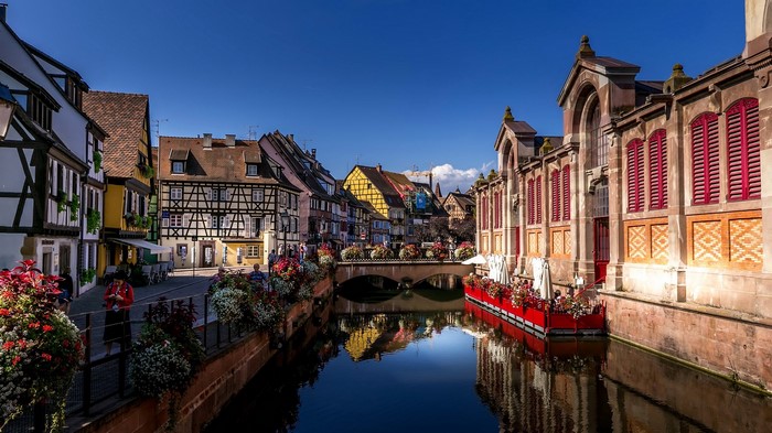 Canal in a French town with reflections