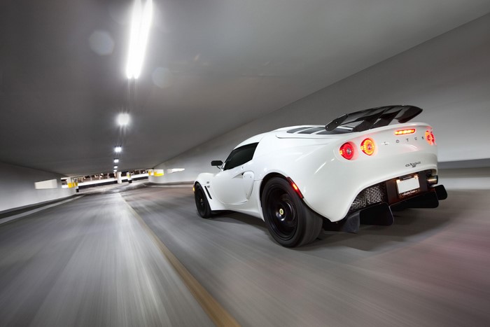 White Lotus Exige driving in a parking garage