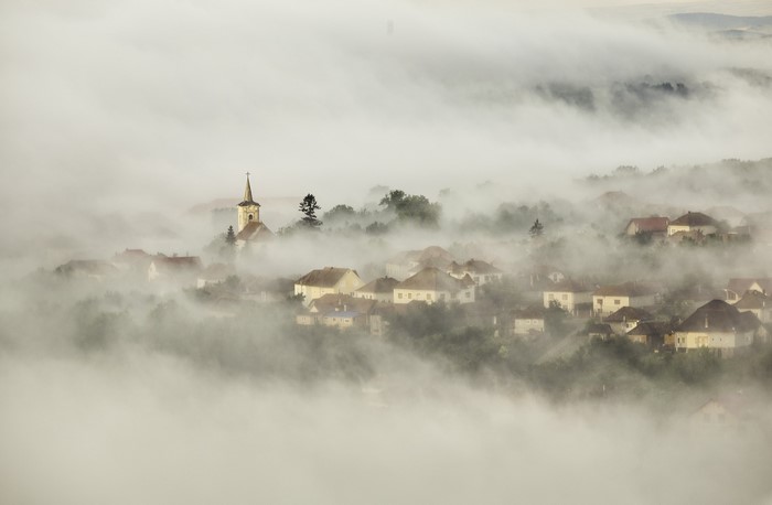 Village church shrouded in mist