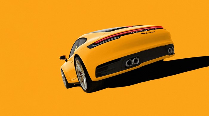 Yellow Porsche 911 Carrera S on orange background